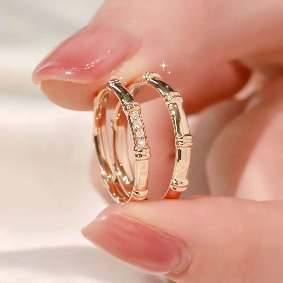 Macro shot of trio of rose-gold bamboo rings, pavé band in focus