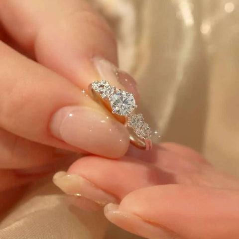 Macro shot highlighting the round center diamond and graduated side stones
